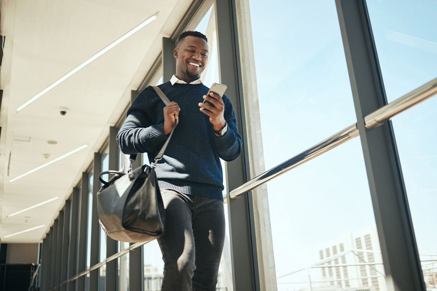Travel business man getting email or social media notification while walking
